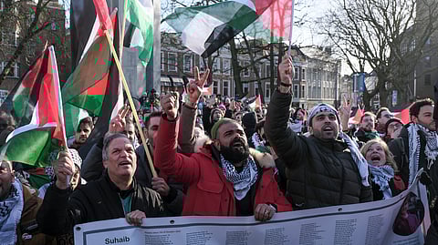 Pro-Palestinian activists react near the International Court of Justice on Friday.