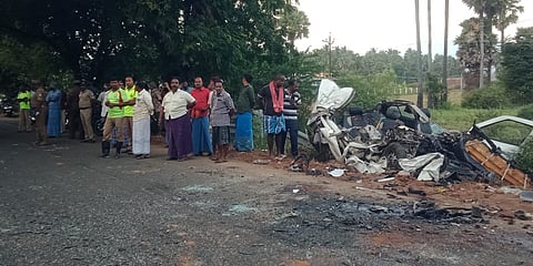 Police and local people seen near the mangled remains of the ill-fated car.