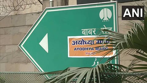 Hindu Sena activists put a sticker of 'Ayodhya Marg' on Babar Road in Delhi.