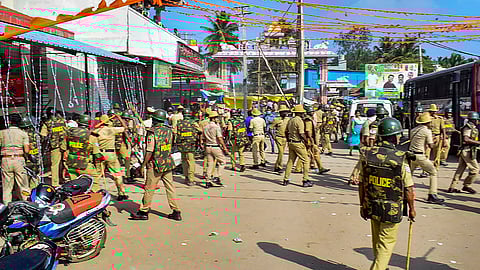 Police personnel deployed to maintain law and order after tension arose due to removal of a saffron flag bearing Lord Hanuman's image hoisted on a 108ft high flag post by authorities, in Mandya district, Monday, Jan. 29, 2024.