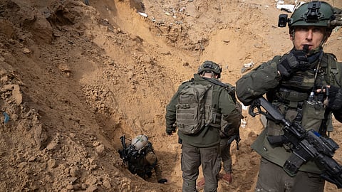 Israeli soldiers enter a Hamas tunnel underneath a cemetery during the ground offensive on the Gaza Strip in Khan Younis, Saturday, Jan. 27, 2024. 