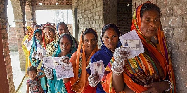 Voters display their identity cards as they stand in a queue to
cast their votes during the Bihar Assembly Elections. (Photo | PTI)
