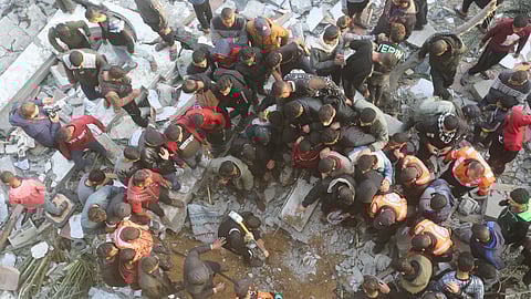 Palestinians look for survivors at a mosque destrooyed in an Israeli strike in Rafah, Gaza Strip. 