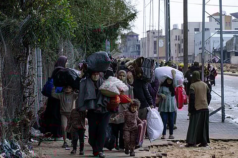 Palestinians gather to fill water jugs near one of the strip's few functioning desalination plants in Deir al-Balah, Gaza Strip.