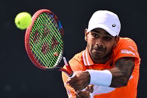India's Sumit Nagal hits a return against Kazakhstan's Alexander Bublik during their men's singles match on day three of the Australian Open tennis tournament in Melbourne on January 16, 2024.