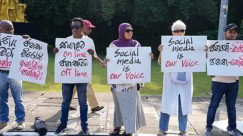 Sri Lankan social media activists hold placards with slogans against the proposed Online Safety Bill during a protest near the Parliament in Colombo. 