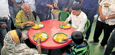 Pandian having lunch with devotees at Samang parking lot in Puri.