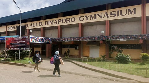 Muslim women walk past the site where a bomb exploded in Marawi, southern Philippines on Dec. 3, 2023. 