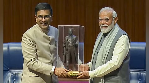 Chief Justice of India D Y Chandrachud hands over a statue of B R Ambedkar to Prime Minister Narendra Modi