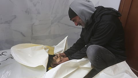 A Palestinian mourns his relatives killed in the Israeli bombardment of the Gaza Strip in a morgue of the European Gaza Hospital in Khan Younis.