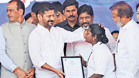Chief Minister A Revanth Reddy blesses a newly appointed nurse as he hands over the appointment letter to her at the LB Stadium on Wednesday.