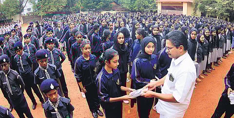 Manoj Kumar gave a copy of The Story of My Experiments with Truth to a student at Ramakrishna Mission HSS in Kozhikode.