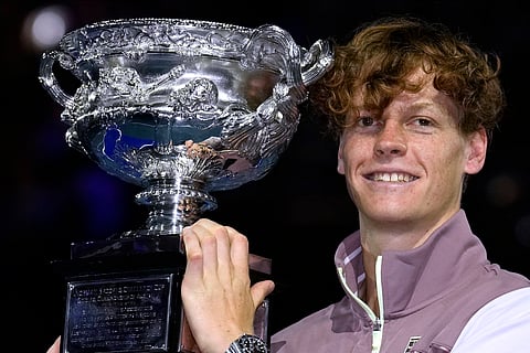 Jannik Sinner of Italy holds the Norman Brookes Challenge Cup aloft after defeating Daniil Medvedev of Russia in the men's singles final at the Australian Open.