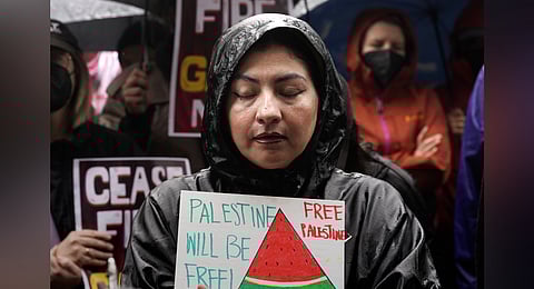 People participate in a sit-in demanding a cease-fire in the Israel-Hamas war at De Longpre Park in Los Angeles, Wednesday, Nov. 15, 2023. 