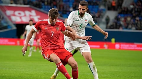 Russia's Aleksandr Sobolev (left) and Iraq's Ali Adnan challenge for the ball during the international friendly soccer match in St.Petersburg, Russia.