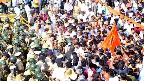 Police try to pacify the protesters at Keragodu village in Mandya district on Sunday.