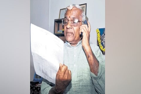 Hiremagaluru Sri Kodandarama Swamy Temple priest Kannan looks at the notice on Tuesday.