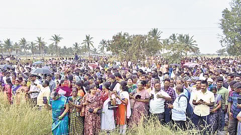People gather near the L&T bypass near Neelambur in Coimbatore district to condemn an FIR against a private firm