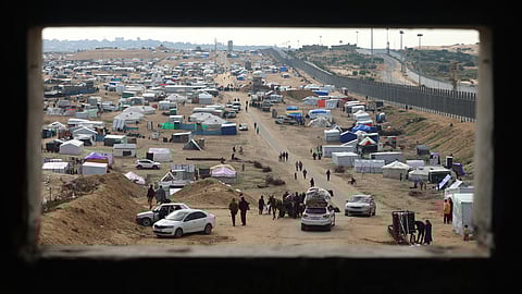 Displaced Palestinians camp near the border fence between Gaza and Egypt, on February 16, 2024 in Rafah, in the southern Gaza Strip, amid the ongoing conflict between Israel and the Palestinian Hamas militant group.