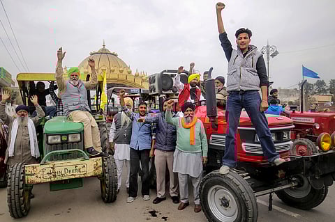 Farmers rasie slogans during a tractor rally taken out in support of the farmers' 'Delhi Chalo' protest, in Amritsar, Monday, Feb. 26, 2024. 