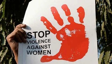 A placard reading 'stop violence against women' seen at a protest march.