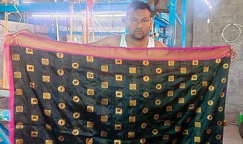 Handloom weaver Nalla Vijay displays his newly woven online saree in Sircilla