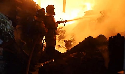 Firefighters work on a fire in Nairobi, Kenya on Friday, February 2, 2024.