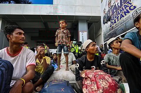Rohingya refugees gather in front of a government building after demonstrating university students forced them to relocate from a previous government facility, in Banda Aceh on December 27, 2023.