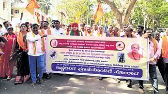 Panchamasali Peetha seer Basava Jayamrithyunjaya Swami takes part in a rally in Shivamogga on Wednesday