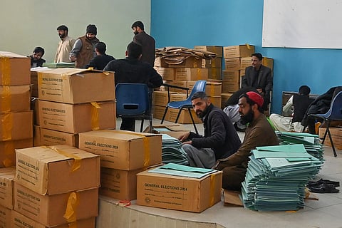 Workers prepare voting materials at a distribution centre in Islamabad on February 6, 2024, ahead of Pakistan's general election.