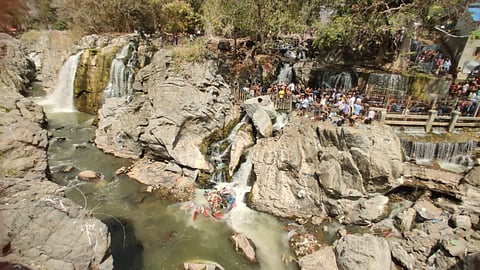 Tourists urge the administration to clean up the waste accumulated in the Cauvery river. 