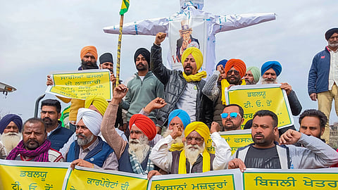 Farmers shout slogans against WTO and corporate houses during a protest as part of their 'Delhi Chalo' march, in Amritsar.