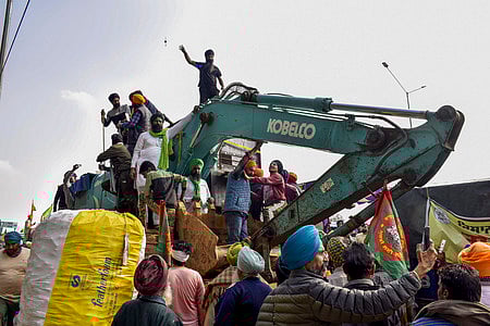 Patiala: Farmers near an excavator modified to shield from police rubber bullets, during their protest over various demands