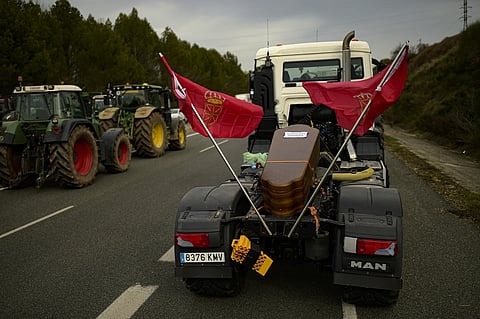 A coffin is displayed on a truck as a symbol of the critical situation of the farmers as they participate in a massive protest, in Tafalla, northern Spain, Wednesday, Feb 7, 2024.