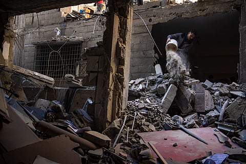Palestinians look at the destruction after an Israeli strike in Rafah, southern Gaza Strip, Thursday, Feb. 8, 2024.