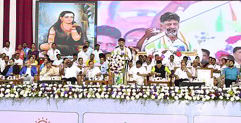 Karnataka Deputy Chief Minister D K Shivakumar speaking at the convention of beneficiaries of the state government’s five guarantee schemes in Shivamogga on Saturday.