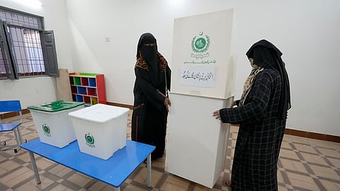 Members of the polling staff set up a polling station for the Feb. 8 parliamentary elections, in Karachi, Pakistan, Wednesday, Feb. 7, 2024. 