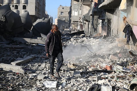 A Palestinian looks at the destruction after an Israeli strike on residential buildings in Rafah, Gaza Strip, Thursday, Fe. 22, 2024