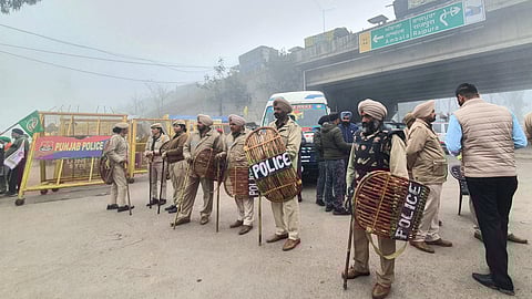 Police personnel stand guard ahead of the protesting farmers' 'Delhi Chalo' march, near the Punjab-Haryana Shambhu Border, in Patiala district, Wednesday, Feb. 21, 2024. 