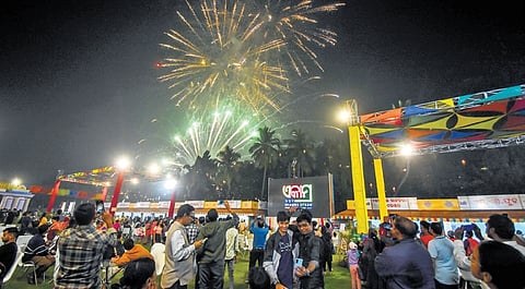 Revellers watch a firecrackers show  on the opening day of Ekamra Utsav at exhibition ground in Bhubaneswar on Saturday