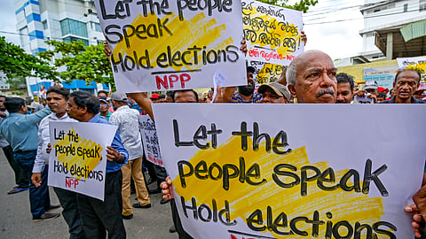 Anti-government demonstrators protest as they urge the holding of general elections, near the Elections Secretariat in Colombo on June 8, 2023.