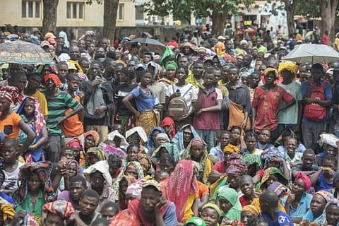 Displaced people from the province of Cabo Delgado gather to received humanitarian aid from the World Food Program (WFP). 