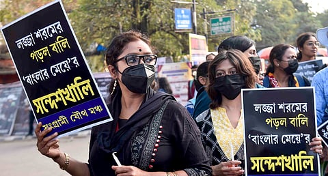 Members of Sangrami Joutha Mancha hold placards during a protest against the Sandeshkhali case, in Kolkata. 