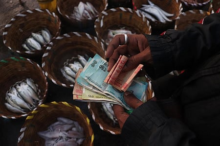 Representational image: A fisherman counts his money at Kasimedu Fishing Harbour in Chennai on the day of the Union budget.
