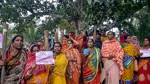 Women holding posters stage a protest over the Sandeshkhali incident allegations in North 24 Parganas district.