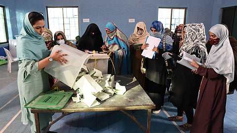 Polling staff opens the ballot boxes in presence of poling agents from various political parties as they start counting votes at the end of country's national elections in Quetta on February 8, 2024.