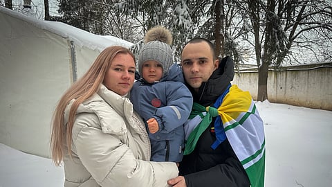 Kateryna Dmytryk, left, and husband Artem Dmytryk hold their son, Timur, after Artem was released from Russian captivity as a part of a prisoner swap in Kyiv, Ukraine, Feb. 9, 2024.