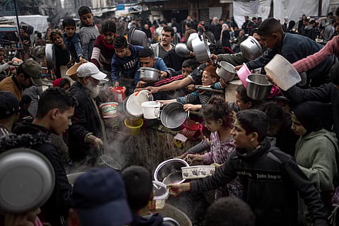 Palestinians line up for a free meal in Rafah, Gaza Strip, Thursday, Dec. 21, 2023. 