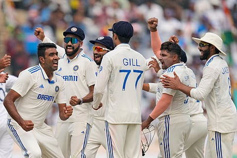 Ravichandran Ashwin, India's leading wicket-taker in home Tests, celebrates with teammates after taking a wicket.
