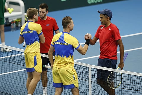 Rajeev Ram, right, and Austin Krajicek of the USA shake hands after their victory to Illya Beloborodko and Oleksii Krutykh of Ukraine during a Davis Cup qualifier doubles tennis match in Vilnius, Lithuania, Feb 2, 2024.
